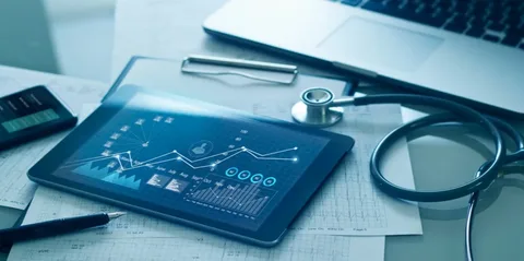 A tablet with graphs and a stethoscope on it.