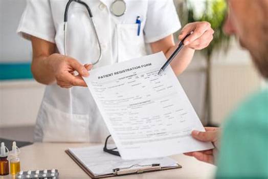 A doctor is holding a patient 's medical record.